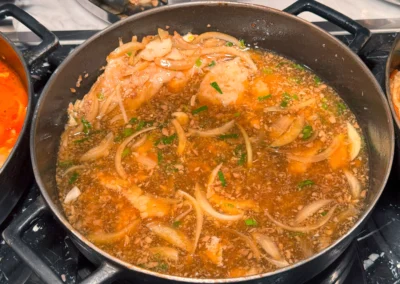 Braised fish fillets simmering in a savory onion and soy-based sauce.
