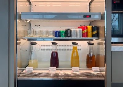Fridge inside the Courtyard Taipei Downtown Executive Lounge stocked with Pepsi, Schweppes, Bogari sparkling water, and assorted fruit juices.