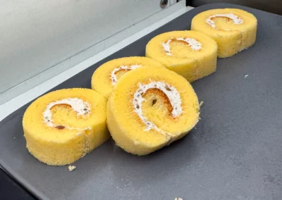 Soft yellow Swiss roll cake slices with cream filling.