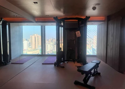 Cable machine and stretching mats with city view from the 17th floor gym at Courtyard Taipei Downtown.