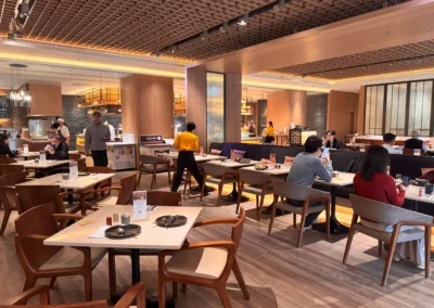 Warm, modern dining area at MJ Kitchen where guests enjoy a relaxing breakfast buffet with plenty of seating.