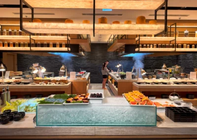 Full view of the vibrant buffet featuring fresh fruit, salad greens, and hot dishes.