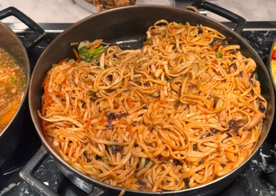 Wok-fried noodles with vegetables and mushrooms.
