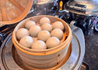 A steamer basket filled with freshly steamed black sesame buns at YEN.