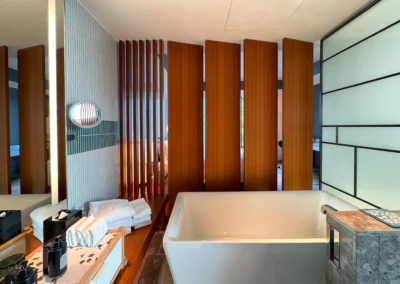 Luxury soaking tub in the Fabulous Room at W Taipei, featuring sleek wood panel dividers and modern design.