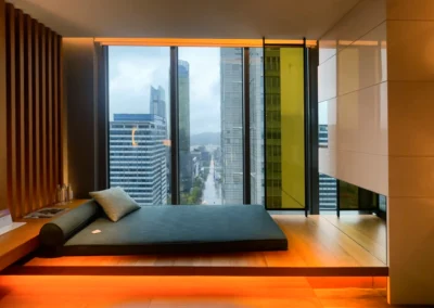 Built-in daybed in the Fabulous Room, Corner Unit at W Taipei, offering a cozy lounging space with panoramic city views and warm ambient lighting.