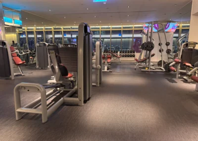 Weightlifting section in the FIT gym at W Taipei, including squat racks, cable machines, and various weightlifting equipment.