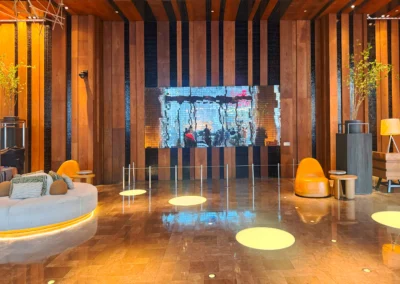 Stylish seating area in the lower lobby, featuring warm lighting and a reflective mosaic wall.