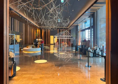 Wide view of W Taipei’s lower lobby featuring modern architecture and a spacious waiting area.