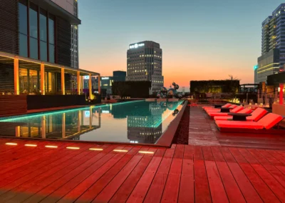 W Taipei pool reflecting city lights in the evening.