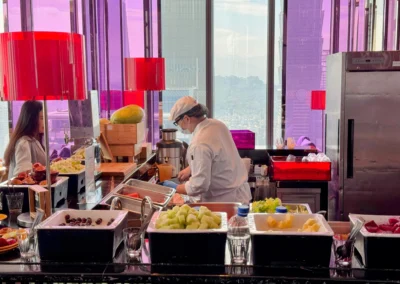 A chef preparing fresh fruit and juices at the breakfast buffet in YEN restaurant.