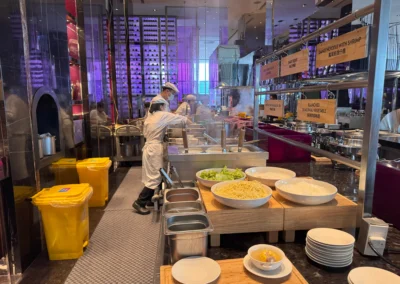 Live noodle station at YEN restaurant in W Taipei's breakfast buffet, offering Danzi noodles with shrimp, seasonal vegetables, and soup options.