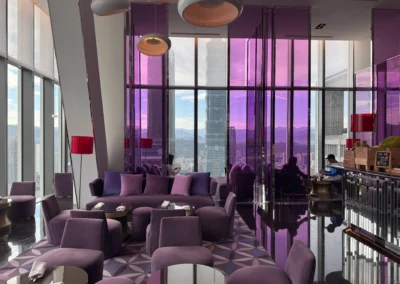 Lounge area at YEN restaurant in W Taipei with plush purple seating, modern decor, and floor-to-ceiling windows offering a view of Taipei 101.